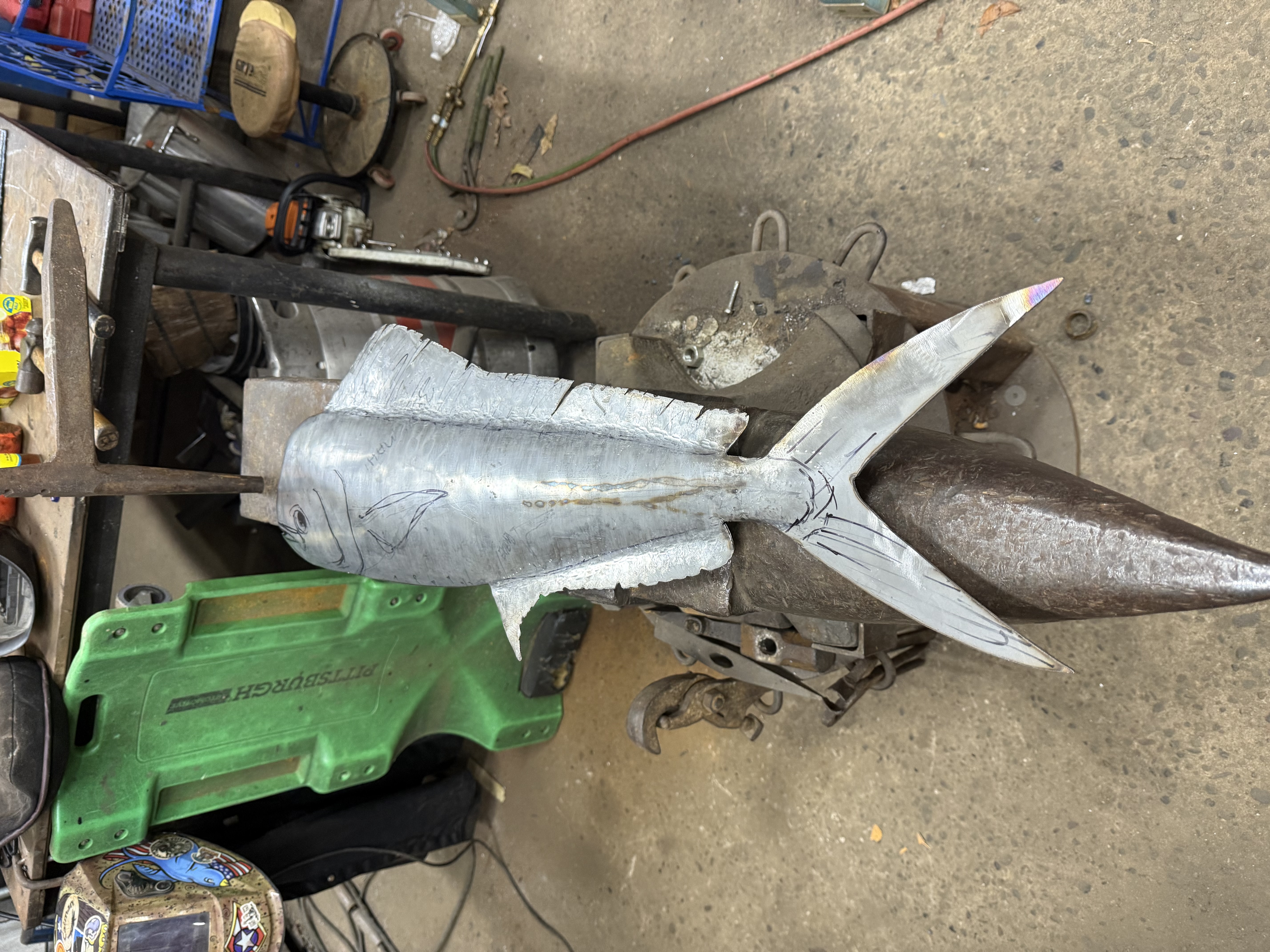 Aluminum mahi-mahi sculpture on a workshop cart