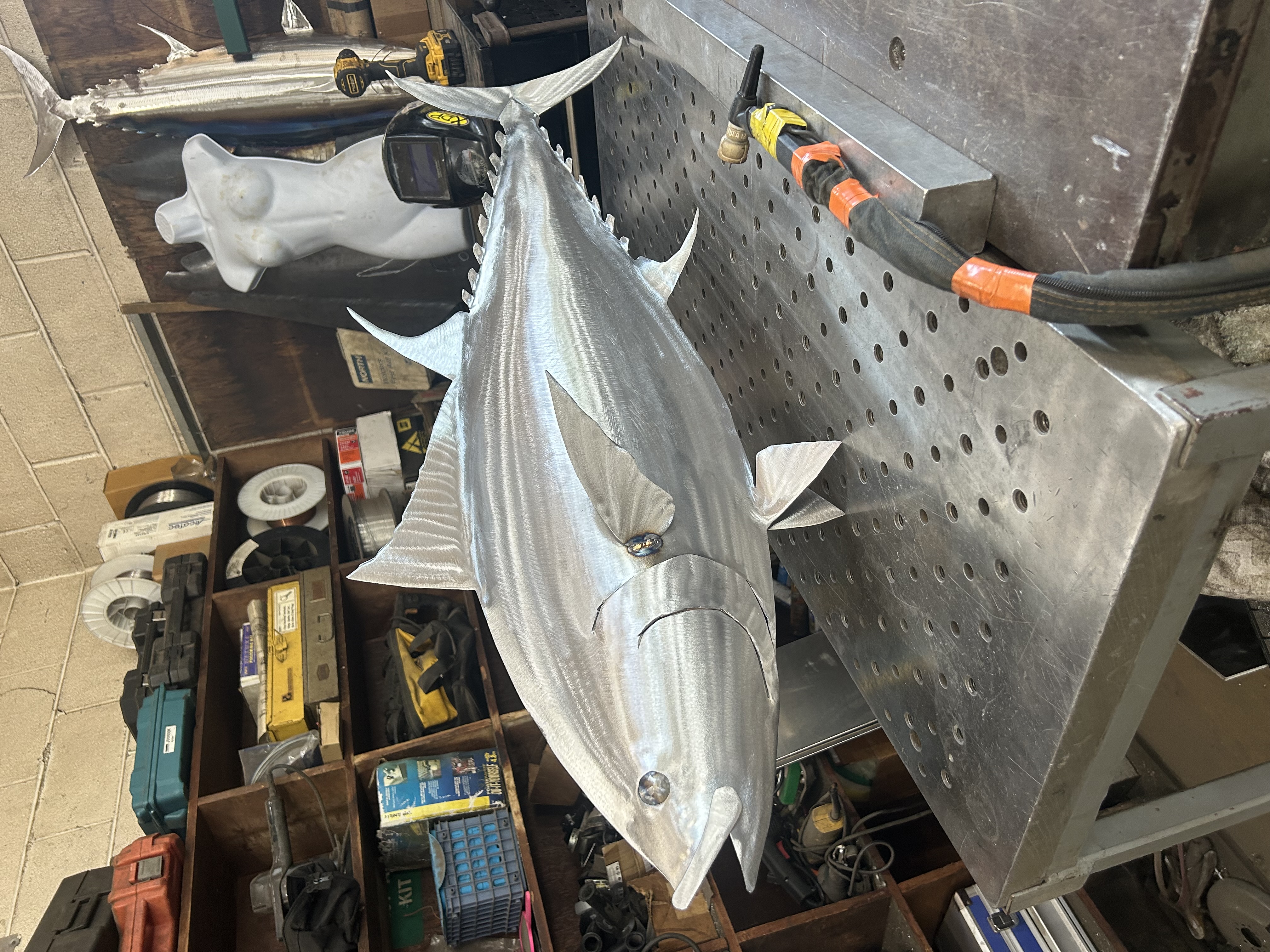 Aluminum tuna sculpture inside the workshop
