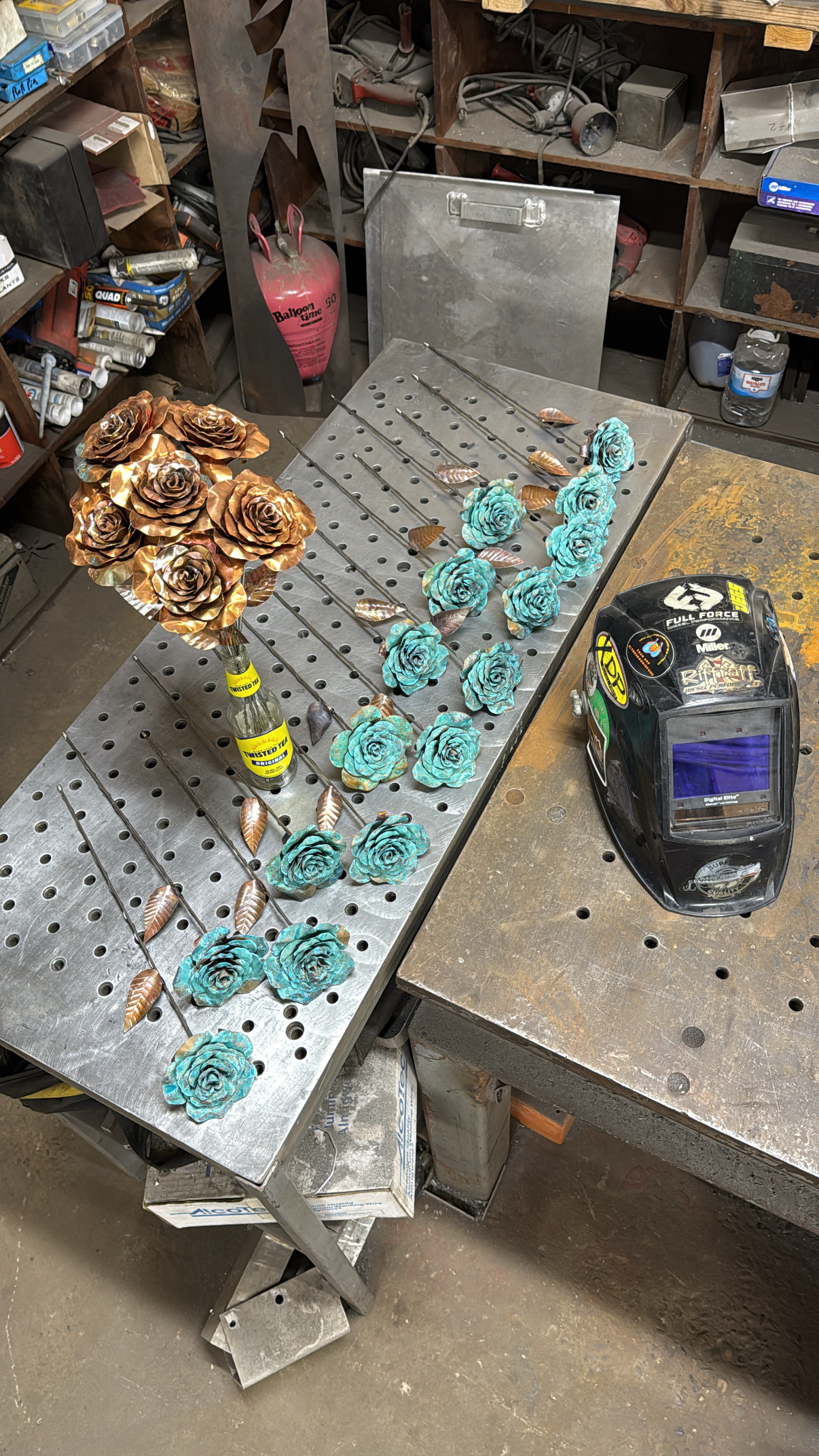 Copper roses arranged across a fabrication table