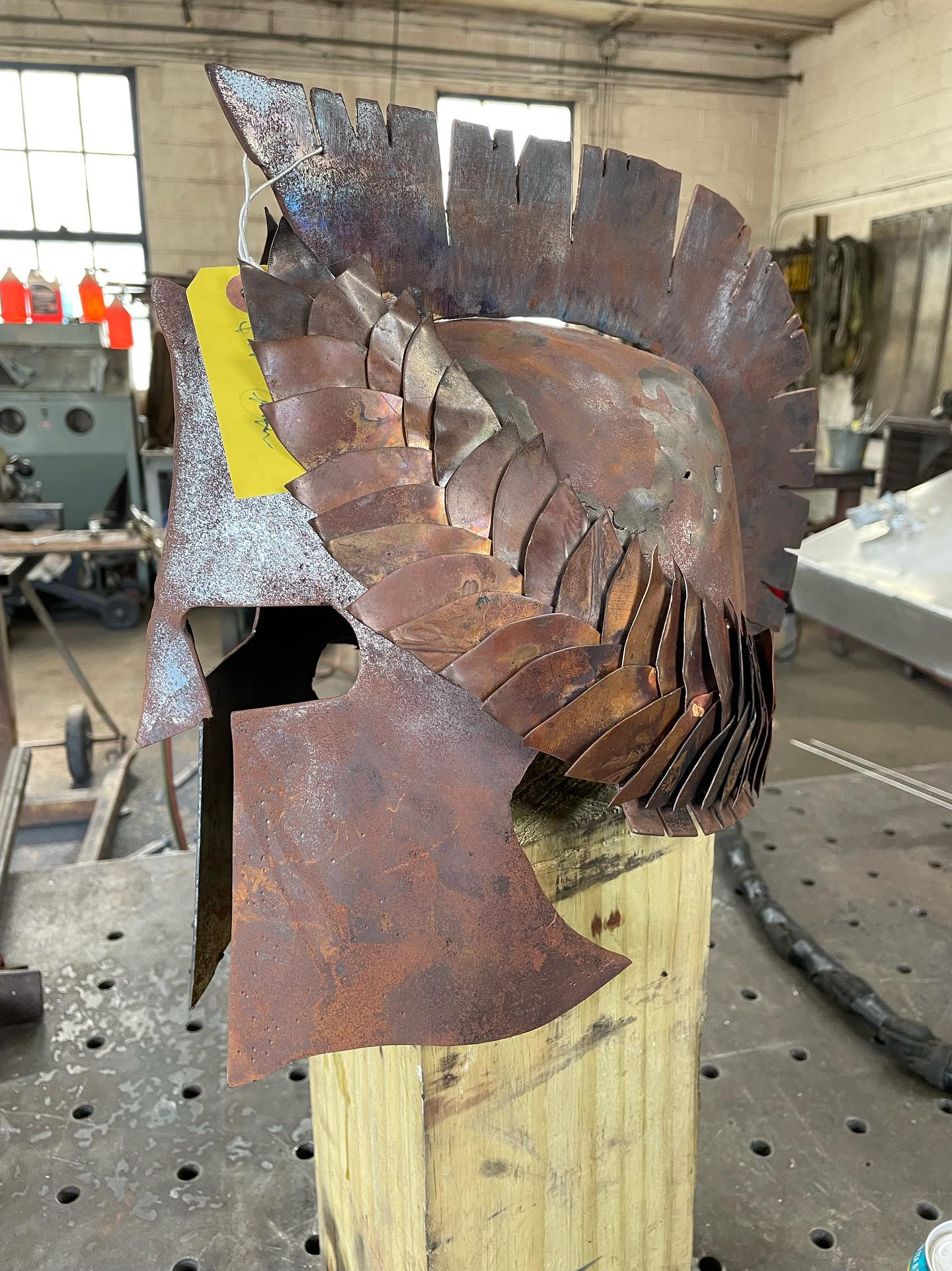 Corten steel helmet with a layered crest