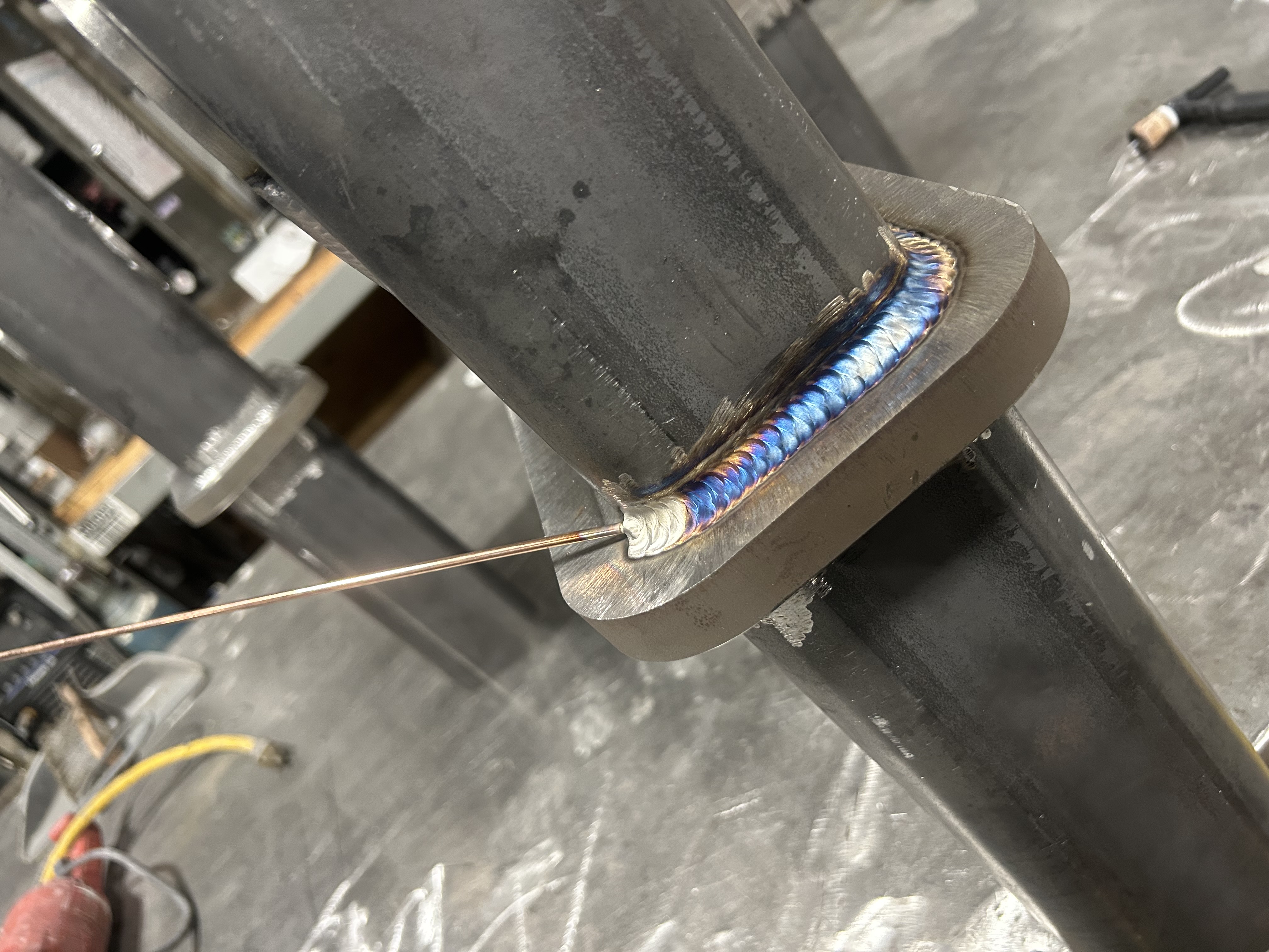 Torch heating metal beside a fresh weld